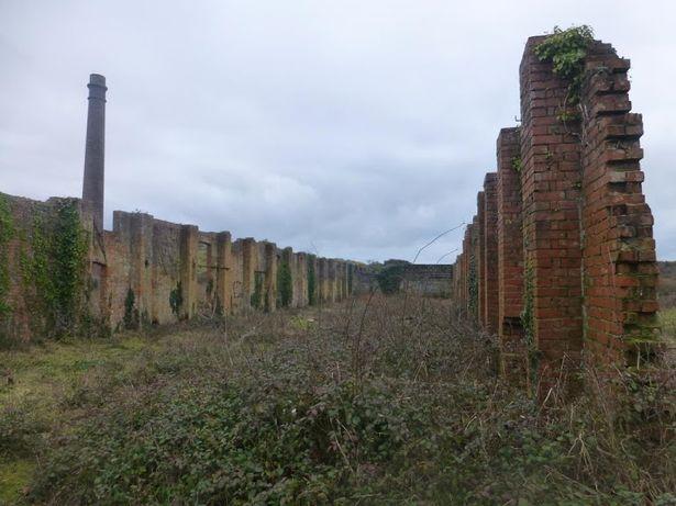 View from inside the remains of the former nitric acid factory to its chimney (the chimney is listed at Grade II) View from inside the remains of the former nitric acid factory to its chimney (the chimney is listed at Grade II)